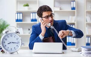 Office professional worried about late payment while speaking on the phone